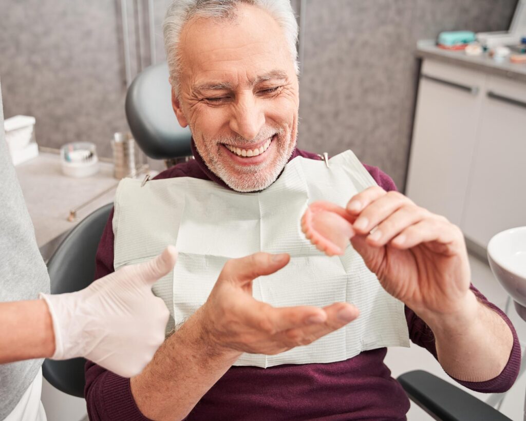 Senior patient received their dentures from the dentist