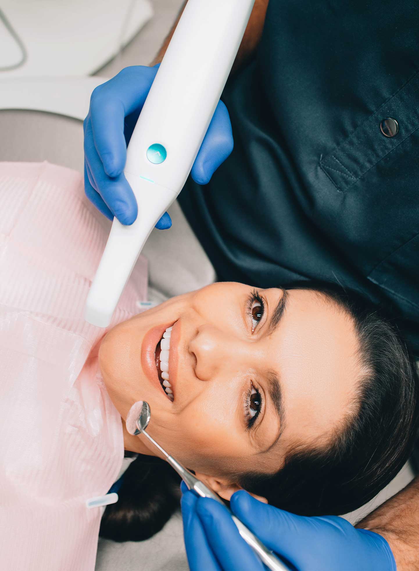 Dentist examining patient after Invisalign treatment