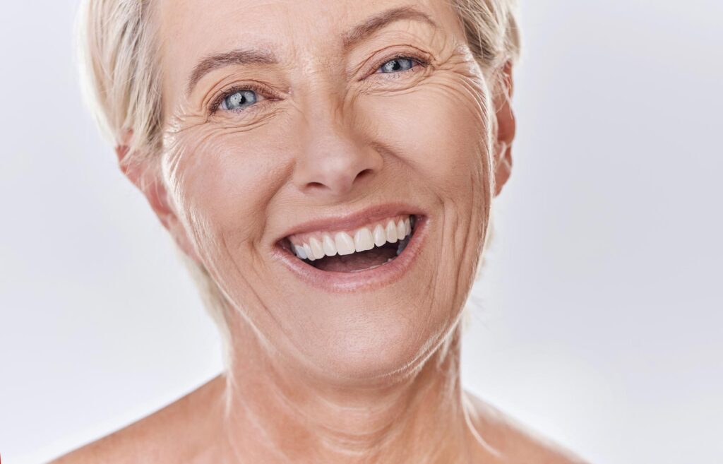 senior woman smiling and happy with her cosmetic dentures