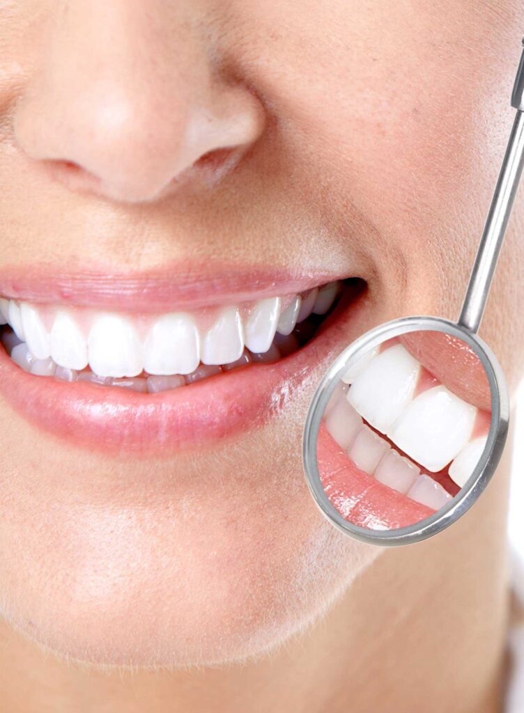 Dentist inspecting teeth and gums during a routine check-up
