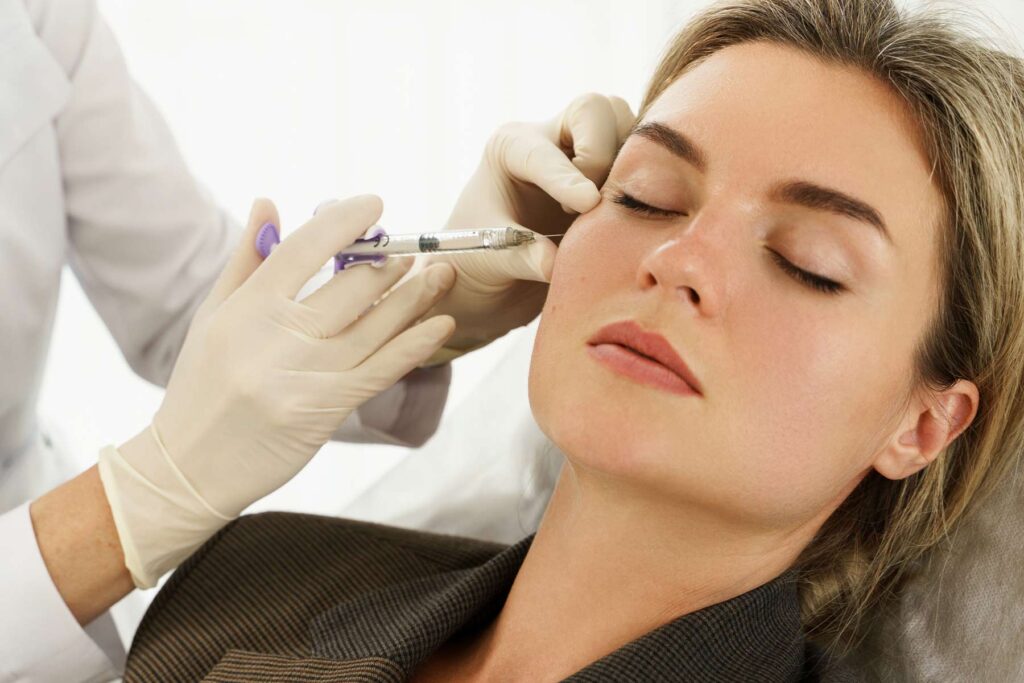 Woman having facial filler injections at the dentist